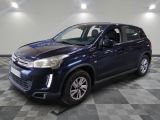 a blue suv parked in a room with a checkered floor