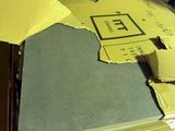 a pile of papers that have been cut up on top of a desk