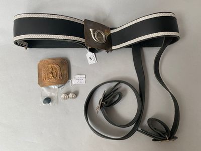 a belt, earphones, and a wooden block on a table