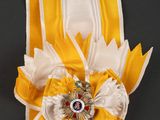 a close up of a ribbon with a flower on it