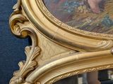 a gold frame with a picture of a woman on it