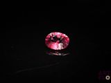 un diamant rose sur une surface noire