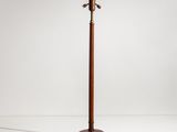a wooden floor lamp with a metal pole on top of it