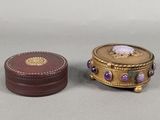 a small box with a purple stone inside of it