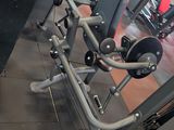 a row of machines in a gym with a sign on the wall