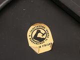 a close up of a black suitcase with a sticker on it