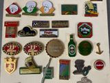 many different types of pins and badges on the wall