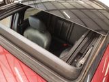 a red car with a black seat in the back of it