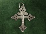 silver cross on a green velvet background