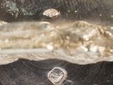 a close up view of a metal object with water coming out of it