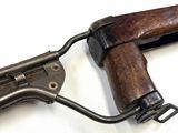 a close up of a gun on a white surface
