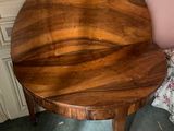 a wooden table with a wooden top on a gray floor