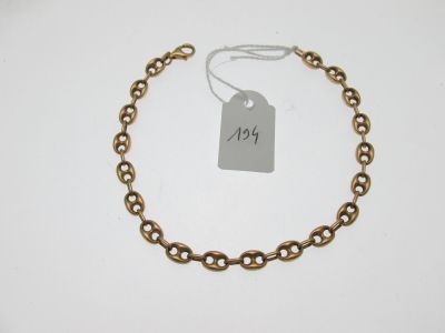 a close up of a chain bracelet with a price tag on it