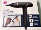 packaging of a hair dryer sitting on top of a table