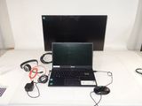 a laptop computer sitting on top of a white table