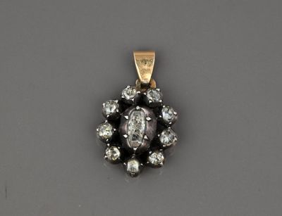 Pendentif ovale en or 18k et argent orné de roses.