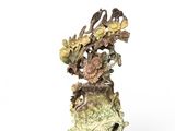 a vase with flowers and birds in it on a stand