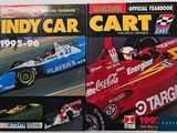 two books on the table with pictures of racing cars