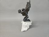 statue of a man on a rock with a sword in his hand