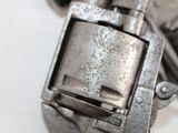 a close up of a gun on a white surface