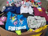 a cardboard box full of t - shirts in a warehouse