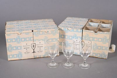 three wine glasses and a wine bottle in a box