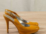 an image of a pair of yellow high heels on a wooden table