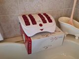 a box of soap sitting on the edge of a bathtub