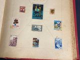 an open book with stamps on it on a table
