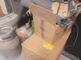 a pile of boxes on the floor next to a toilet