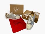 shoes and a red bag are sitting next to a shoe box