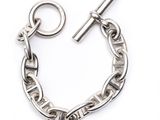 a close up of a chain bracelet with a clasp on a white background