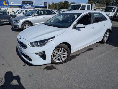the white car is parked in the parking lot near other cars