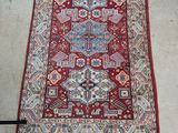 un tapis oriental posé au sol, à côté de toilettes blanches