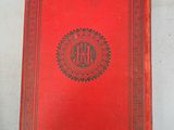 a red book sitting on top of a white table