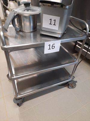 a metal cart with a mixer on it in a kitchen