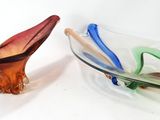 two glass bowls sitting next to each other on a white surface