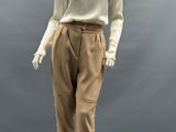 an image of a mannequin wearing a beige top and brown pants