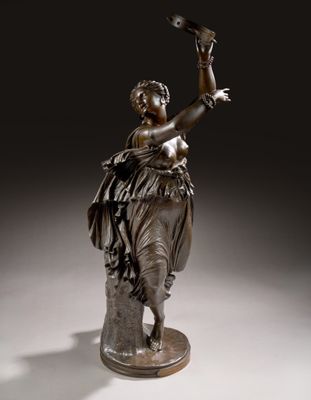 an image of a bronze statue of a woman holding a bird