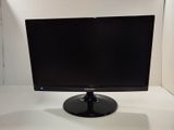 a computer monitor sitting on top of a white table