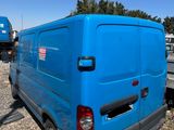 a blue van that is parked on the side of the road