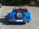 a blue car that is parked in a parking lot