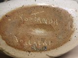 a close up of a vase with writing on it
