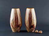 pair of hand painted vases sitting on top of a table