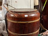a large wooden bucket sitting on top of a green box