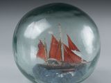 a glass ball with a ship inside of it