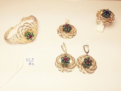 a white table with a bunch of jewelry on it