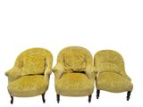 three yellow chairs sitting next to each other on a white surface