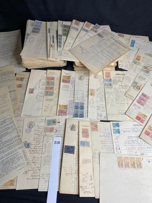 a pile of old letters and stamps on a table