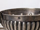 a silver bowl that is sitting on a table